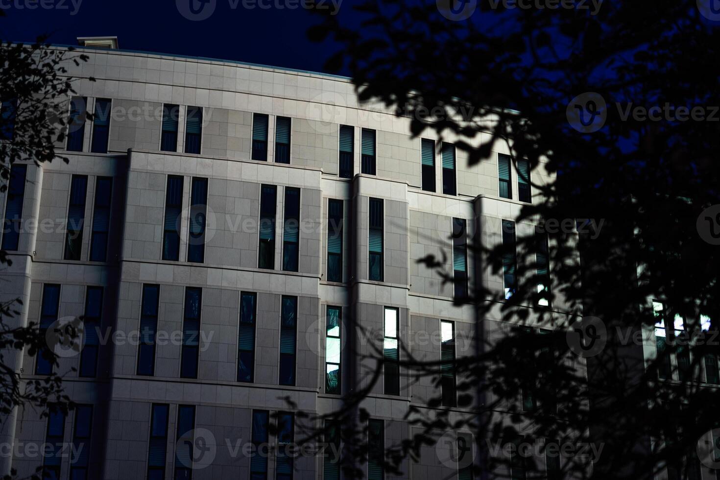 The business building in the form of a wave is illuminated late at night photo
