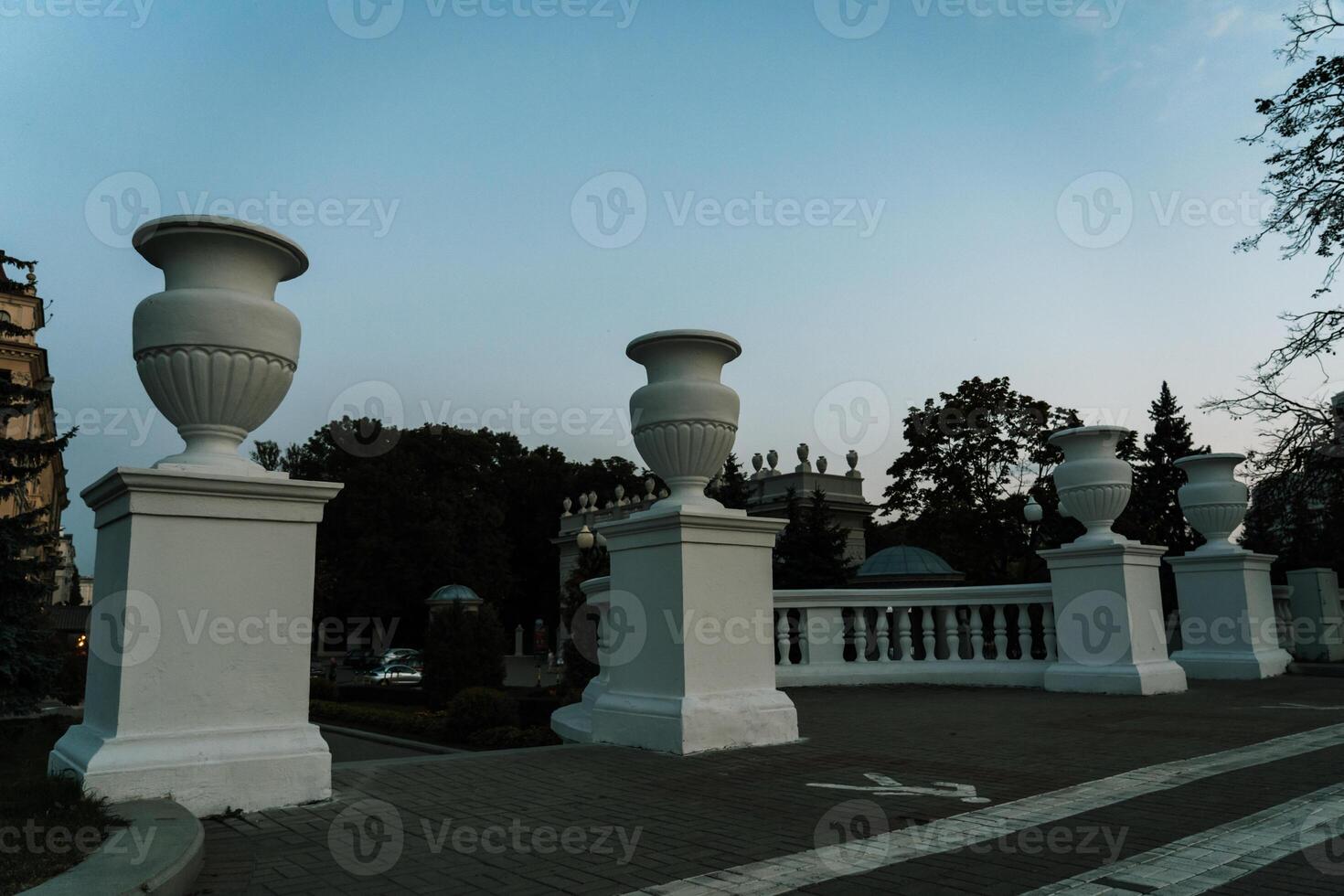 Concrete columns with capitals and bases on them. Entrance to the park photo