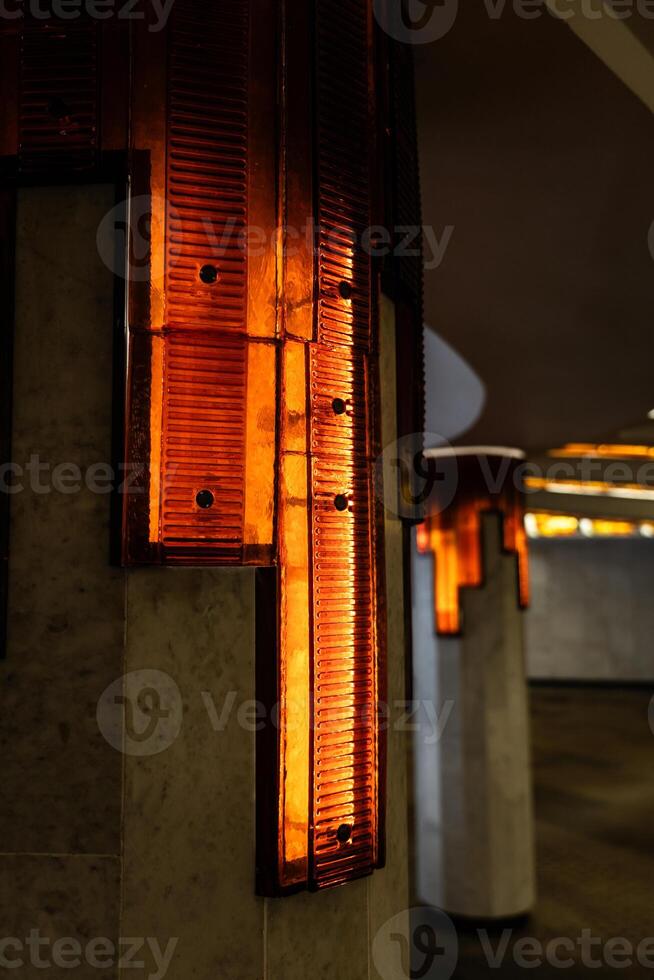 Lighting of columns in the underpass. Orange lighting. Decorative lighting photo