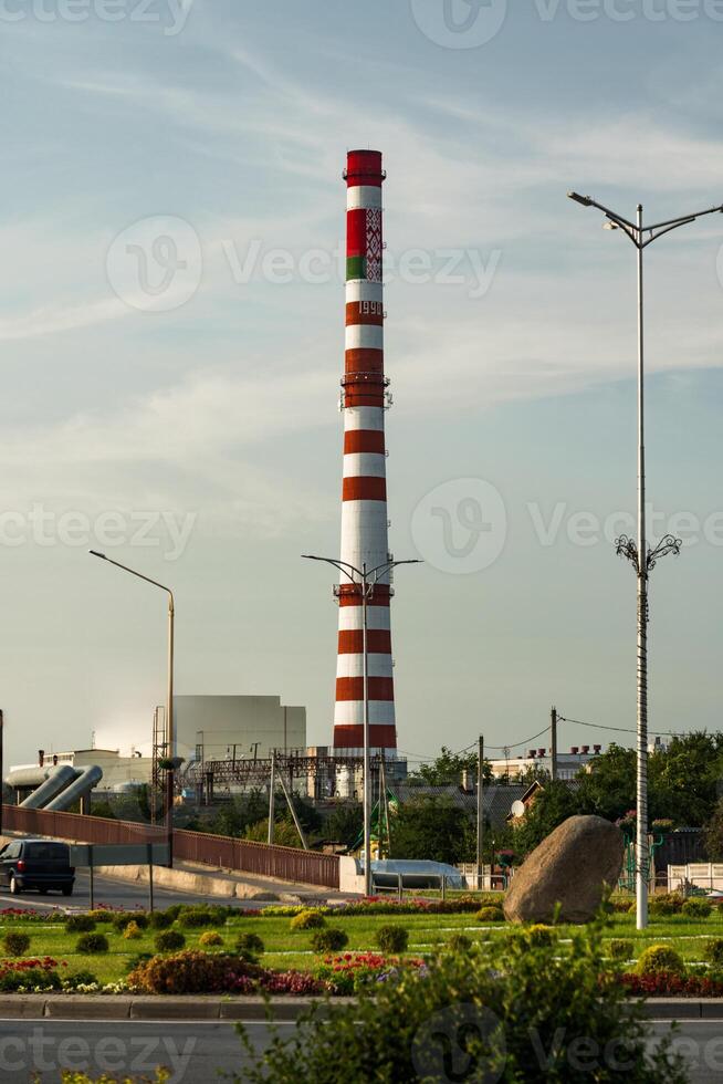 The tall, red and white striped pipe of the factory in the city of Baranovichi photo