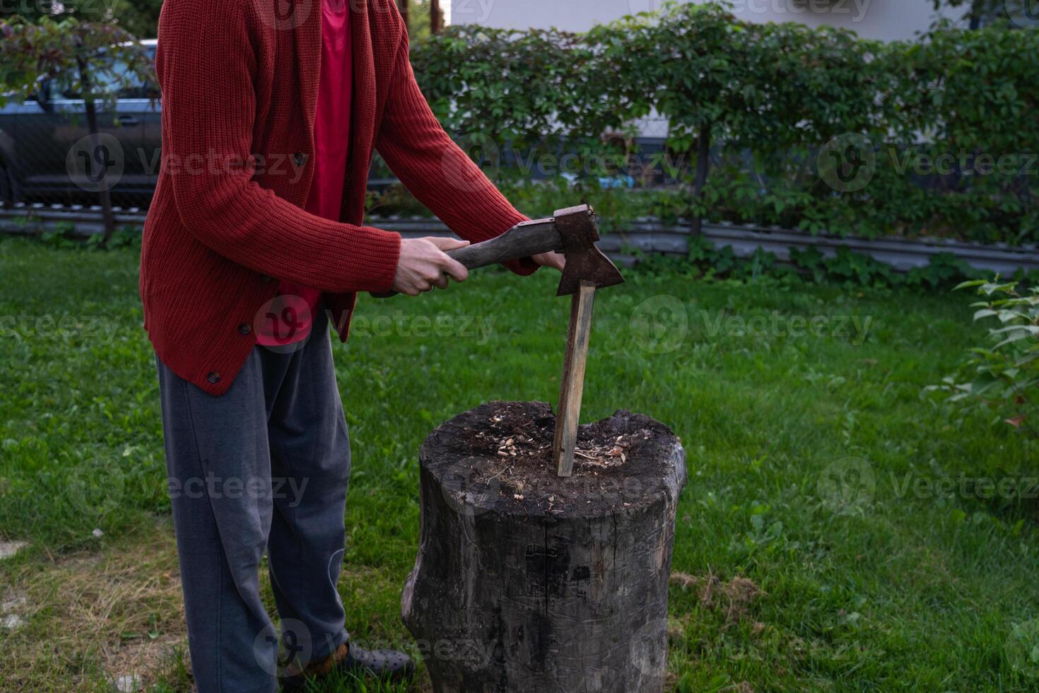 A man is chopping wood for a bonfir A man is chopping small firewood. Evening photo