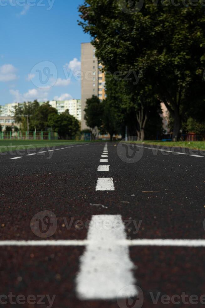 A rubber treadmill at the stadium. White markings. Gusty marking line photo