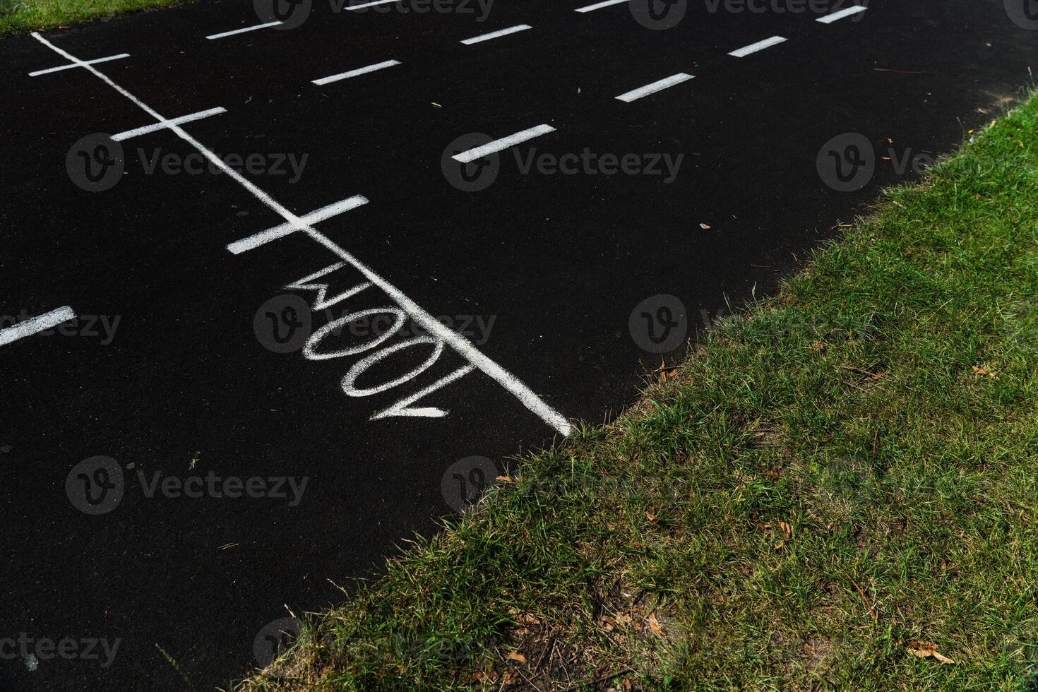 A rubber treadmill at the stadium. White markings on the stadium track photo