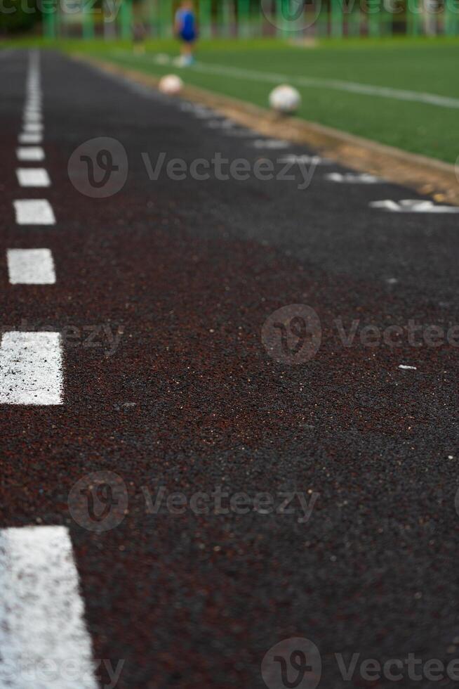 A blustery line on the rubber track of the school stadium photo