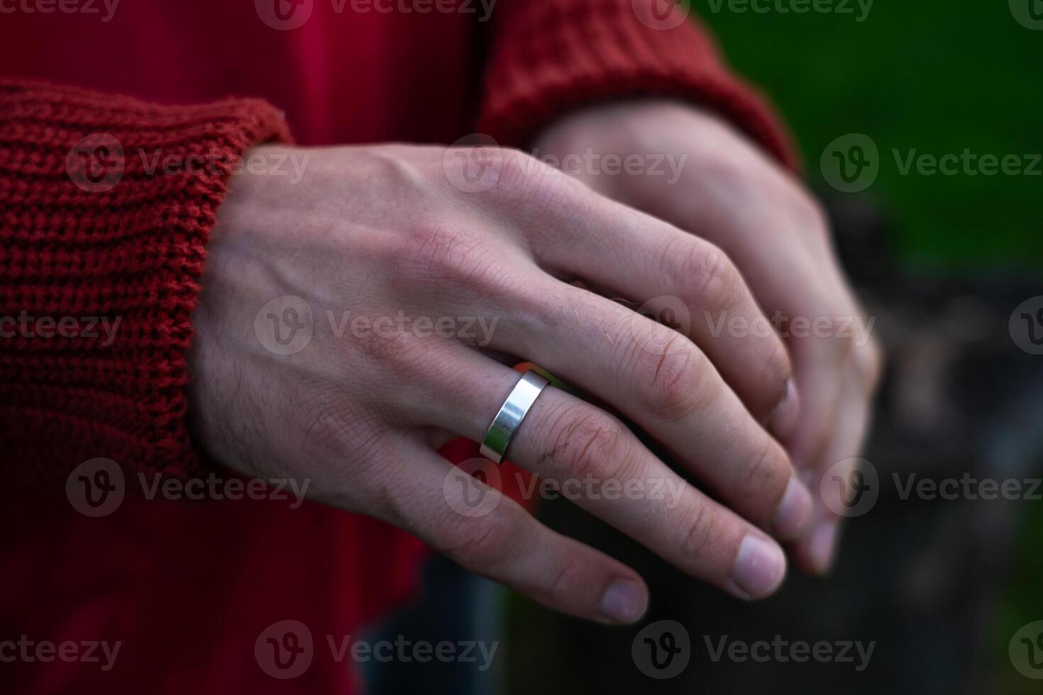 Empty palms of a man up close in a sweater. An engagement ring on her finger photo