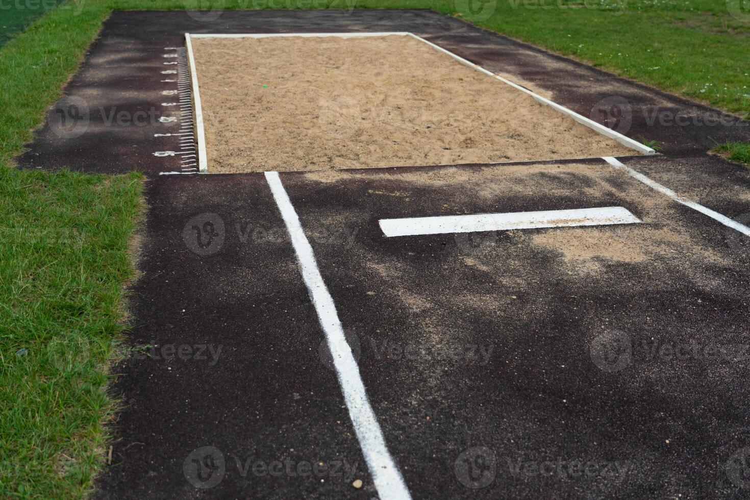 The jump pit at the school stadium. Long jump in the sand photo