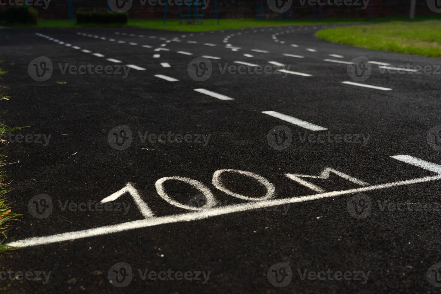 A rubber treadmill at the stadium. White markings on the stadium track photo