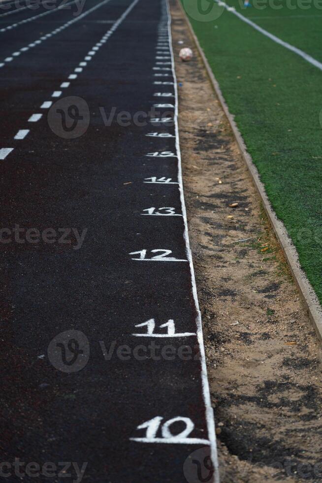 Marking the rubber track of the stadium. Meters on the treadmill. School Stadium photo