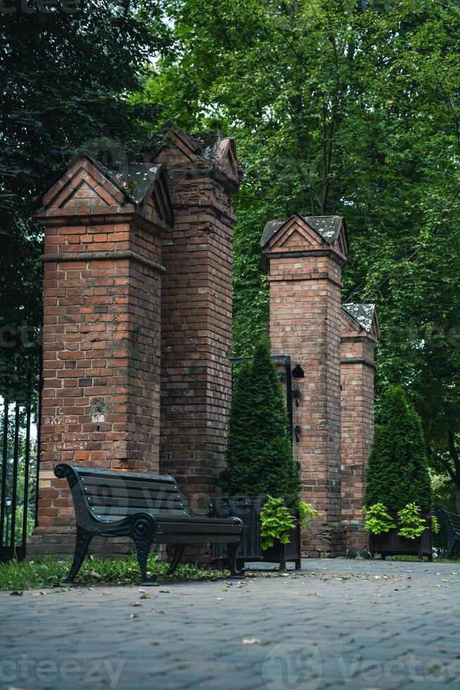 Brick columns are the entrance to the park. Gates in the forest park photo