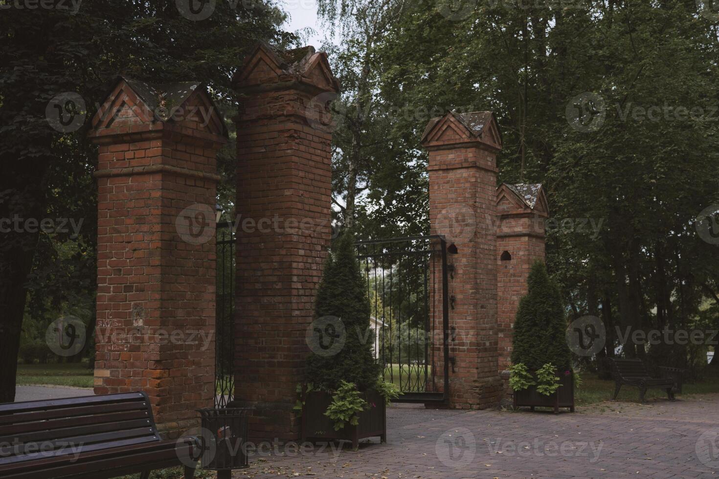 Brick columns are the entrance to the park. Gates in the forest park photo