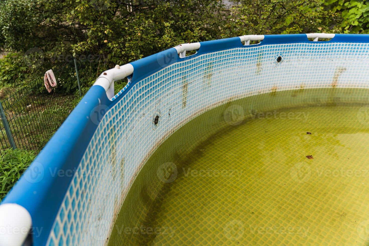 A green-framed swimming pool in the backyard of the site photo