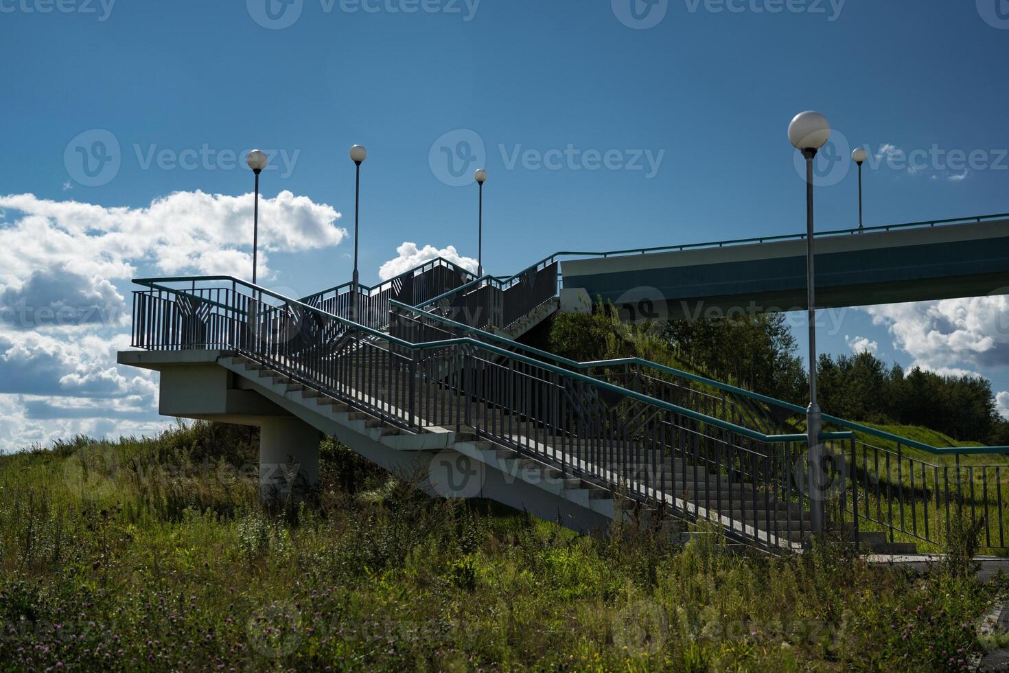 A pedestrian bridge over the highway. Steps for climbing the bridge photo