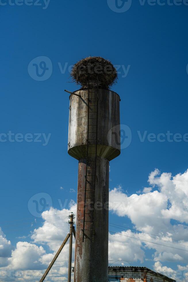The stork's nest on the water tower. Clear sky. The clouds. Minimalism photo