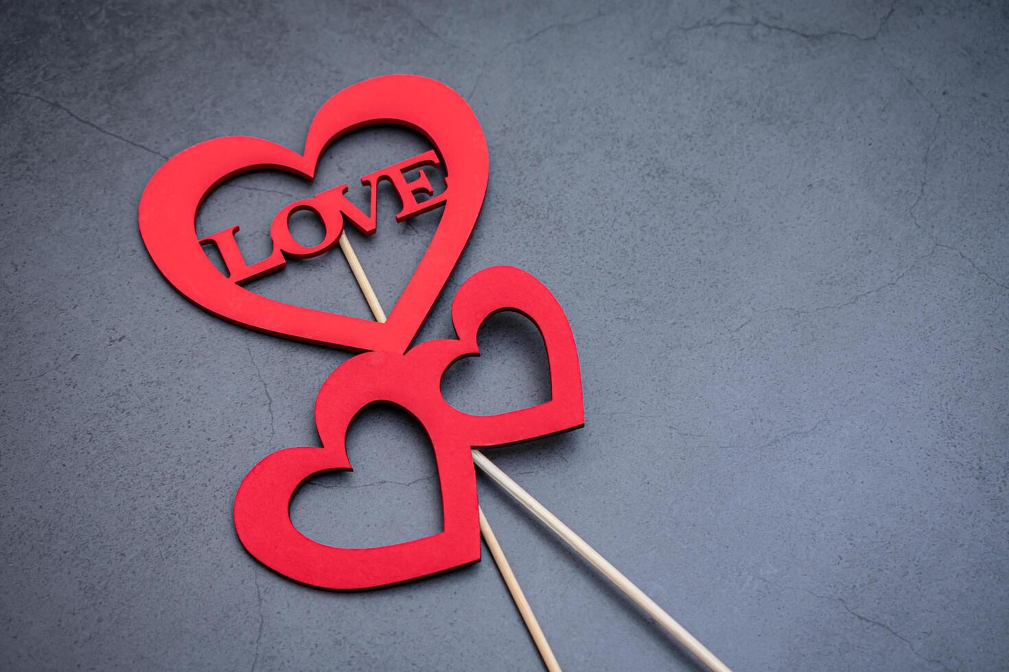Heart-shaped signs with the word love to express your feelings to your loved ones on a dark background photo