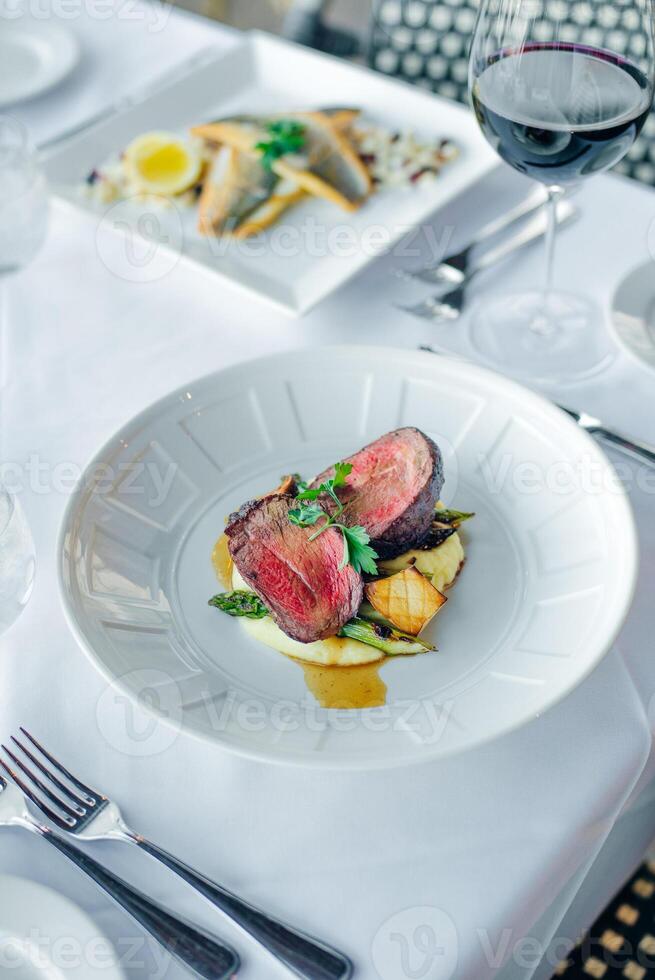 Closeup of a steak with vegetables in a restaurant setting photo