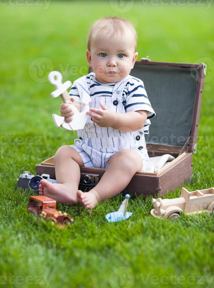 Portrait of the smiling baby boy playing outdoors photo