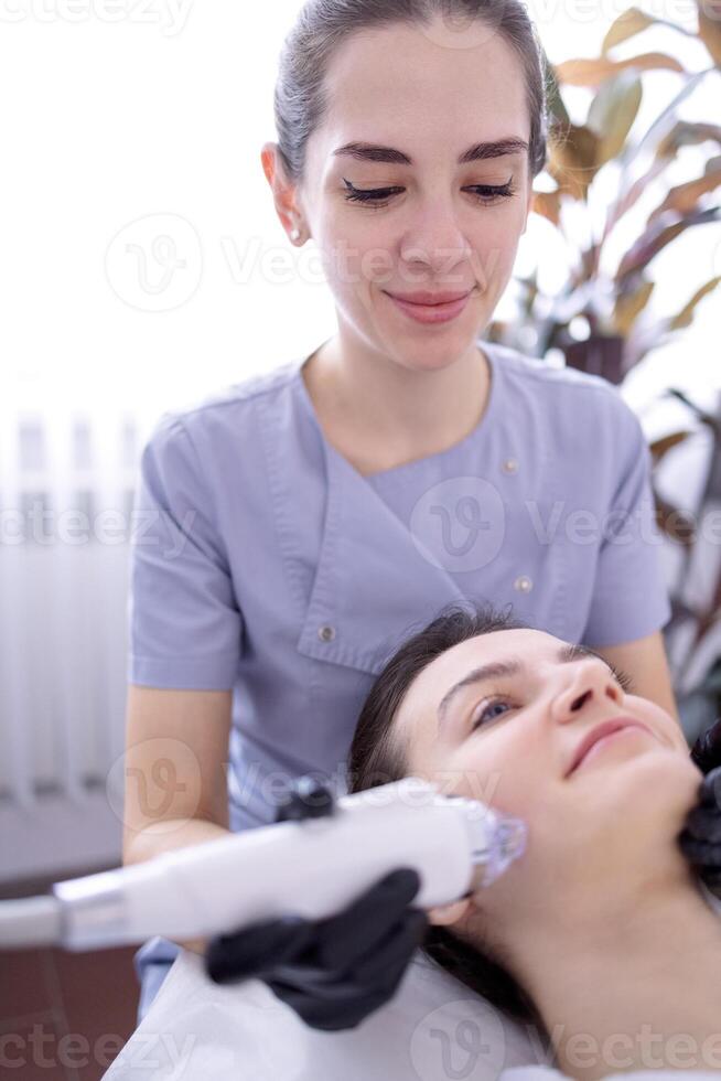 Microneedle RF lifting procedure. Hardware cosmetology. photo