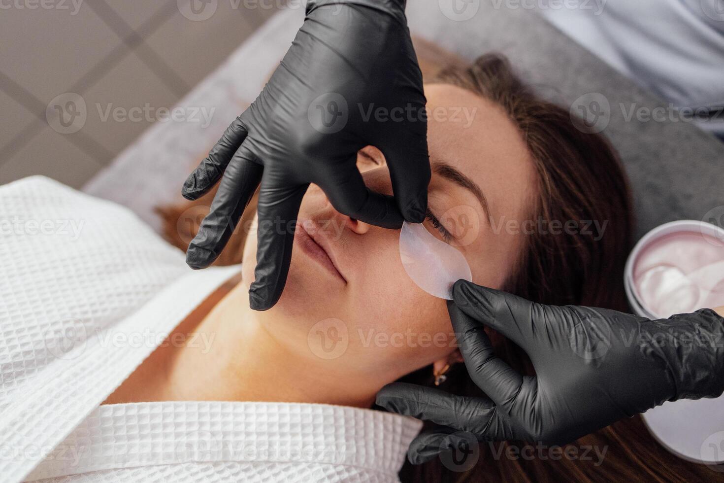 a woman getting her eye makeup done photo