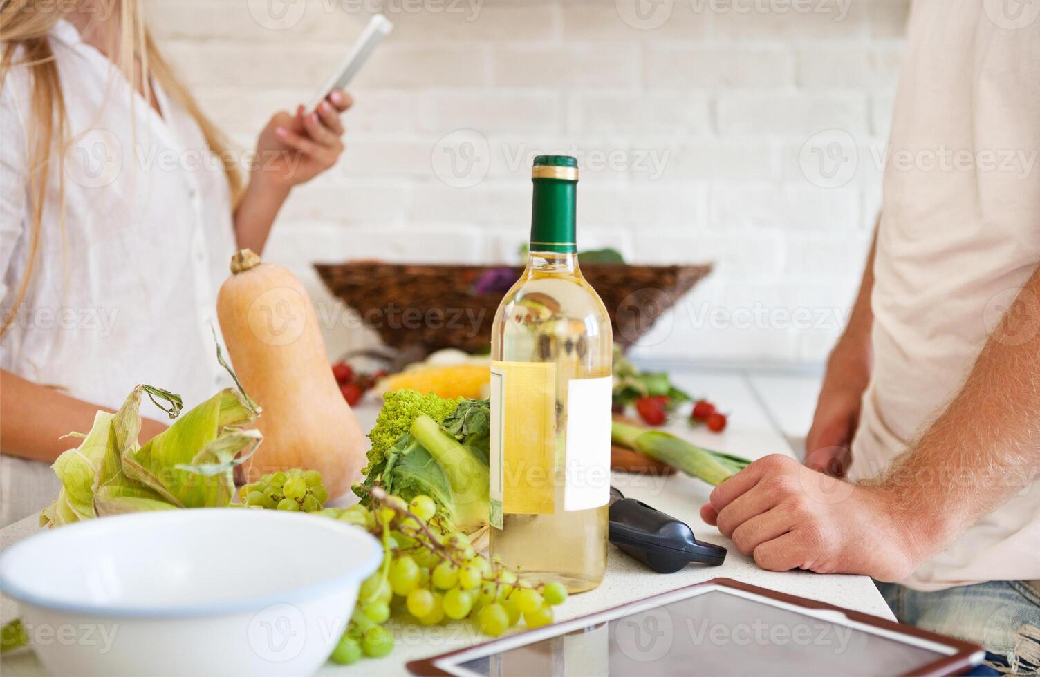 Young couple cutting vegetables at the kitchen photo