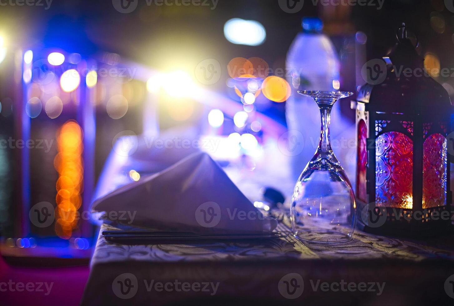Wineglass outdoors on table by night photo