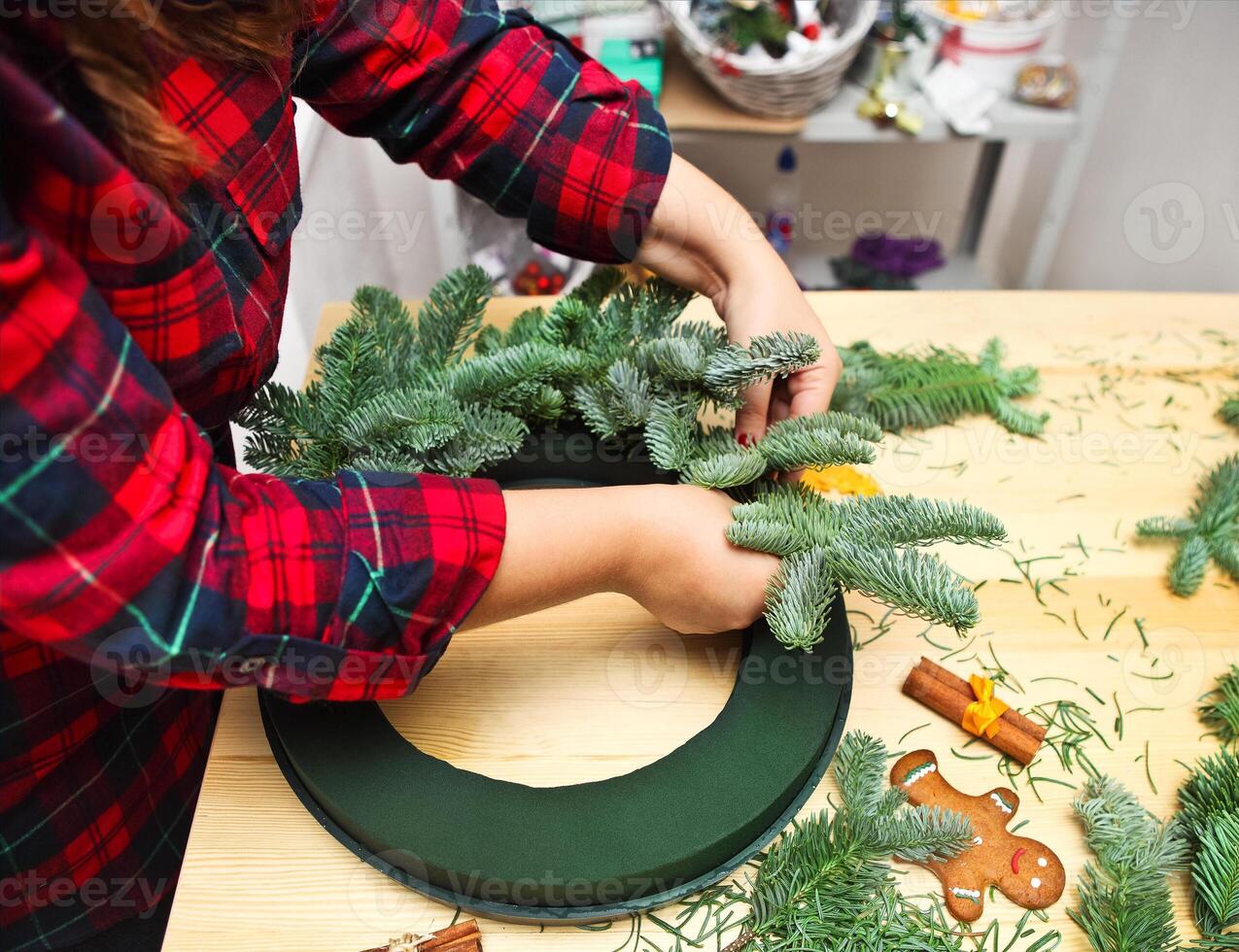 Woman spinning and decorating Christmas wreath photo