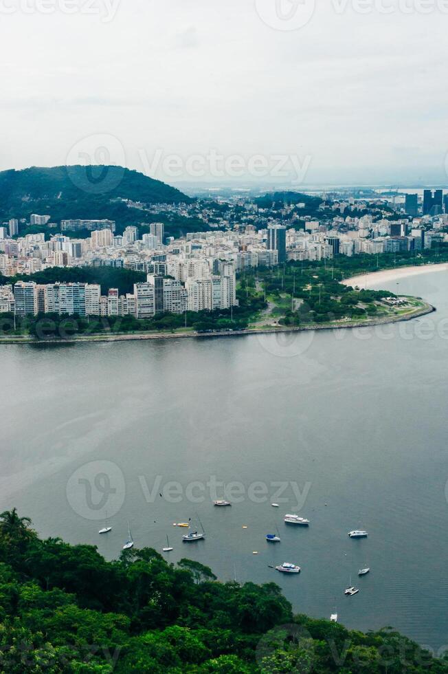 View from bottom of Sugarloaf mountain just dusk overlooking boats on Guanabara bay photo