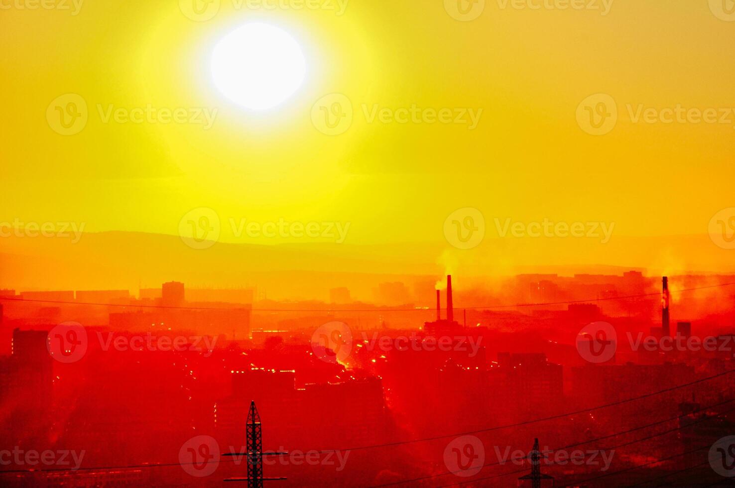 Smoke from heating station in big city during winter season at sunset. photo