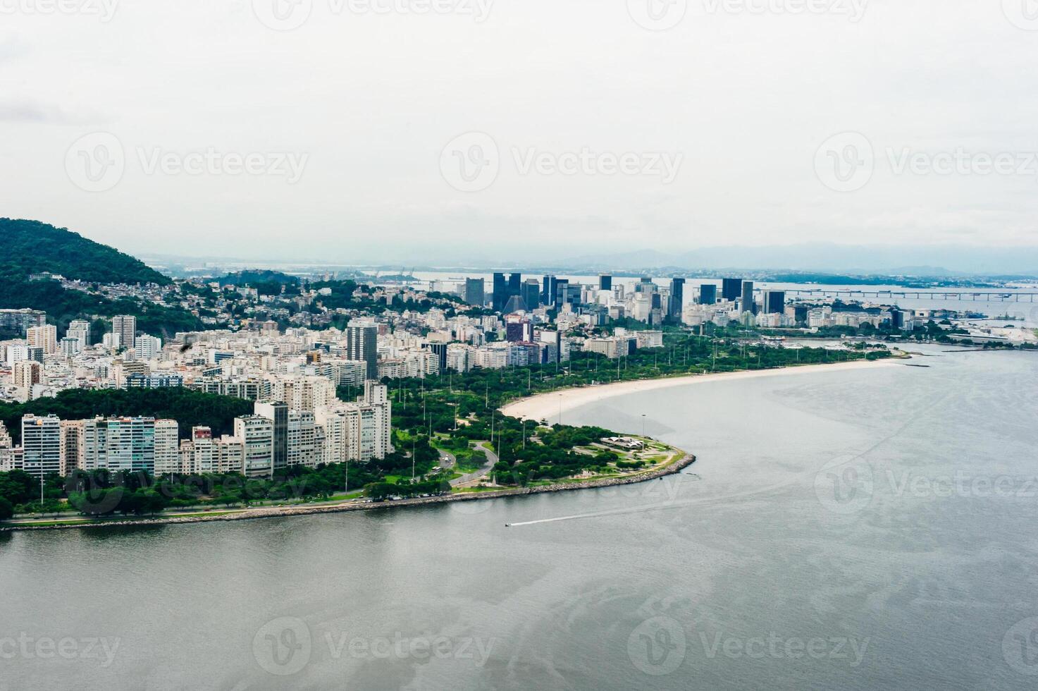 View from bottom of Sugarloaf mountain just dusk overlooking boats on Guanabara bay photo