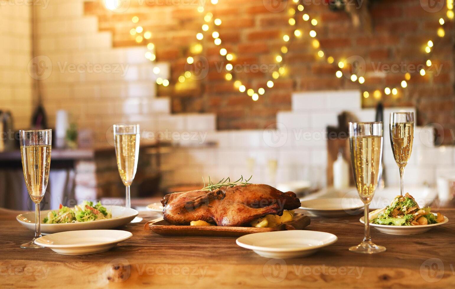 Winter holiday family dinner with roast poultry and champagne photo