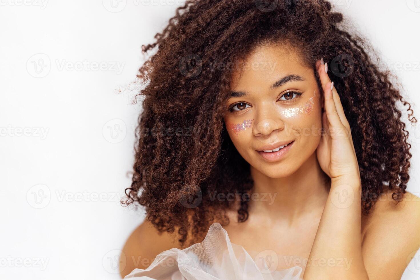 Charming african american with perfect skin and sequins on her cheeks photo