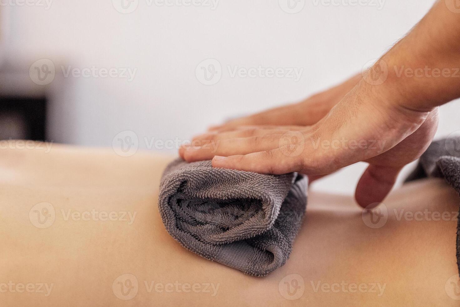 Close-up of neat male masseur hands lying on a towel photo