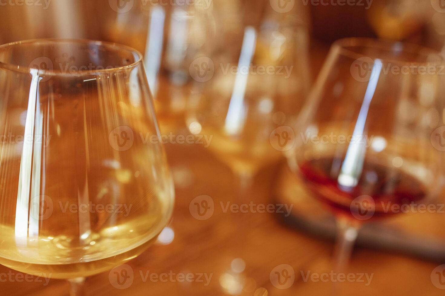 Glass goblets placed in rows on table during wine tasting procedure in restaurant photo