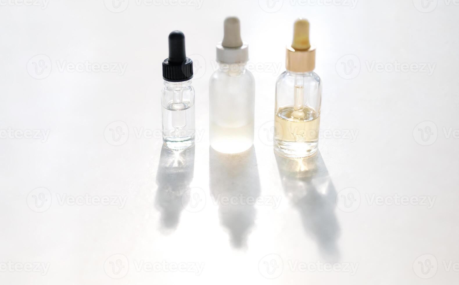 Serum with collagen and peptides in colorful glass bottles on light background photo