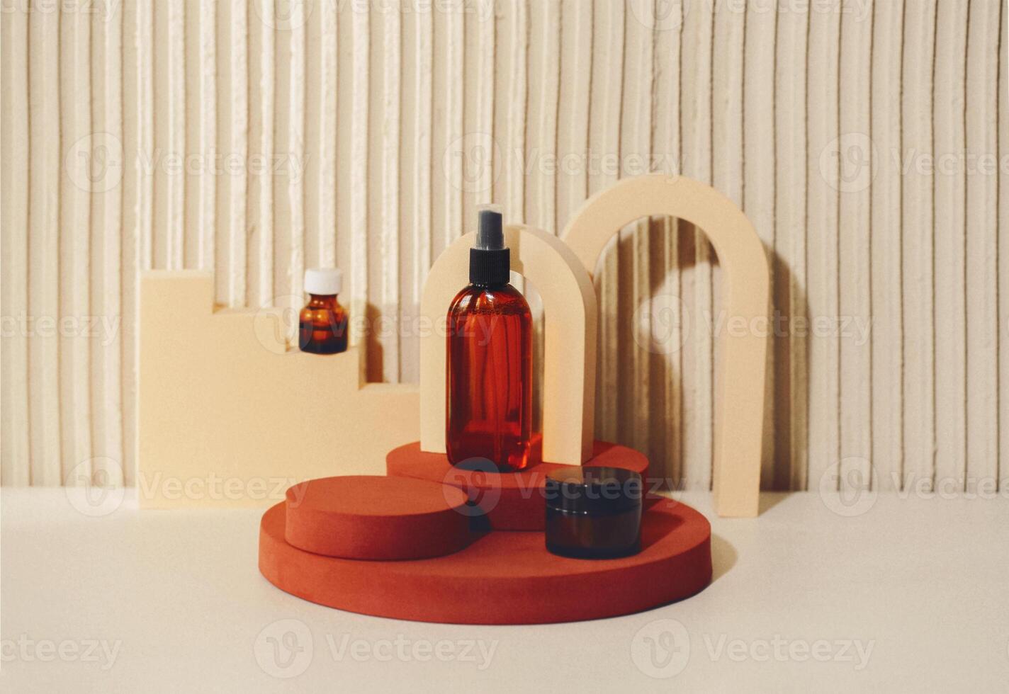 Abstract composition with cosmetic skincare products in glass bottles standing on round podium against texture beige background, copy space for text. photo