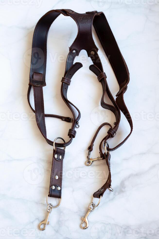Leather strap for a photographer - a shoulder strap for two cameras. Top view with copy space. photo