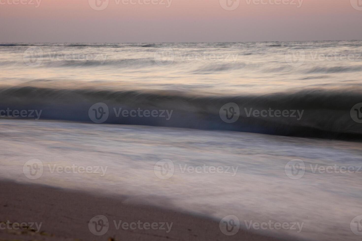 Seascape. Waves and surf. Sunset and dawn at sea. Calm on the ocean. Beautiful sky and clouds illuminated by the sun. Natural background. Summer time. photo