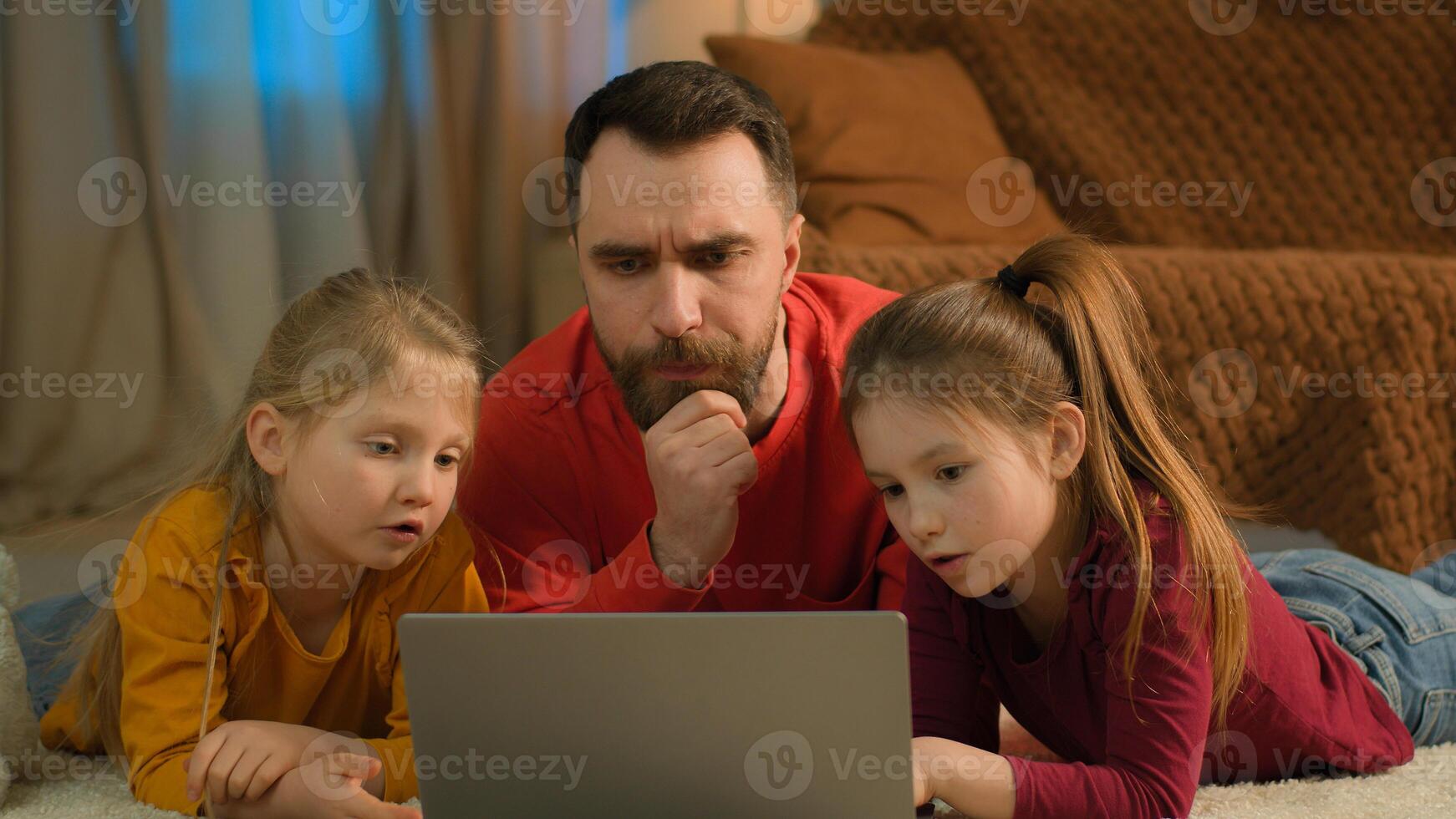 Caucasian dad children kids little girls using computer watch laptop at home single parent father teach daughters help parental control difficult problem with online education school homework learning photo
