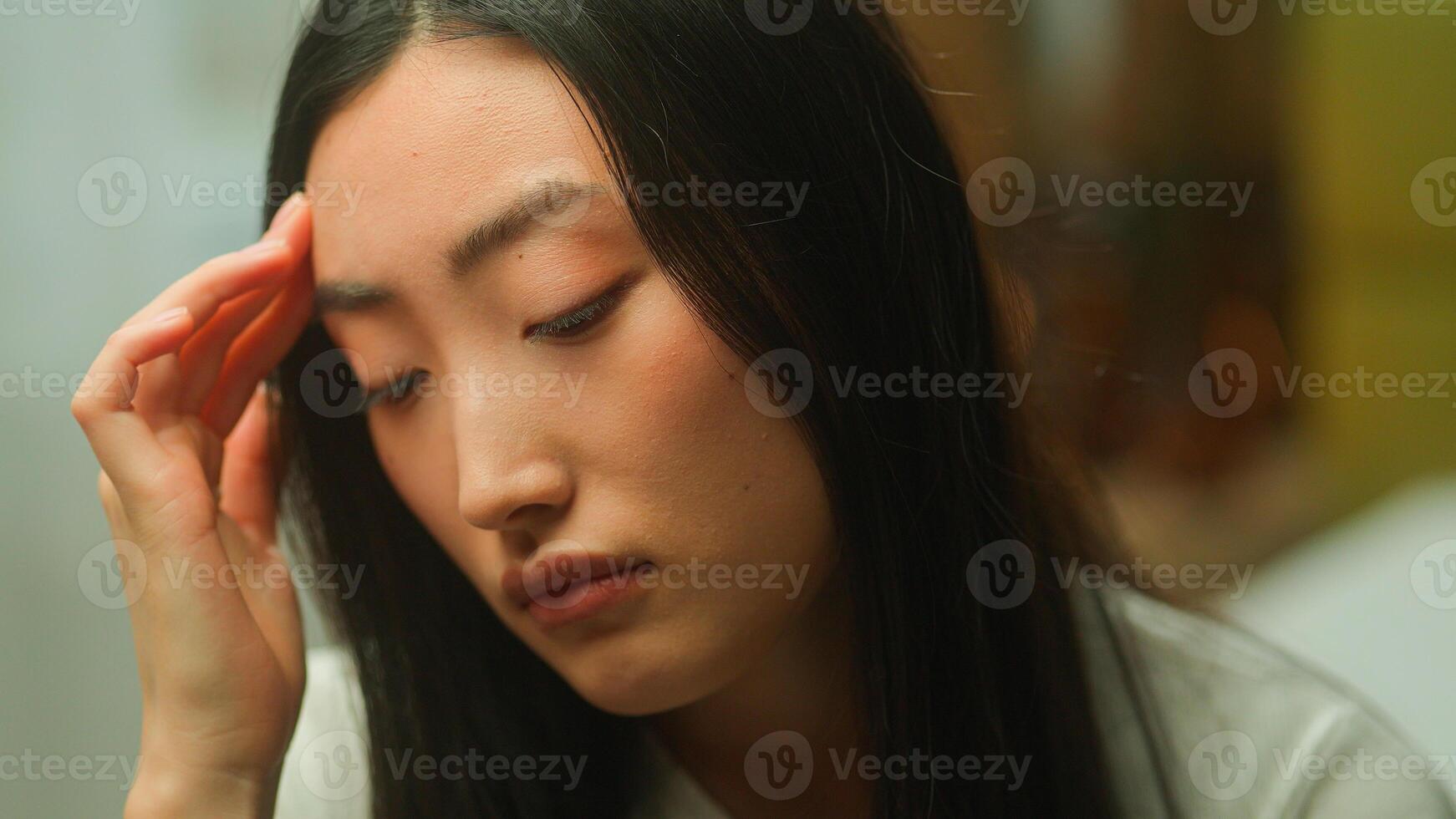 Sad lonely frustrated upset Asian Korean woman girl lady student businesswoman stressed tired Chinese Japanese female headache health problem worried suffer depression displeased close up face emotion photo