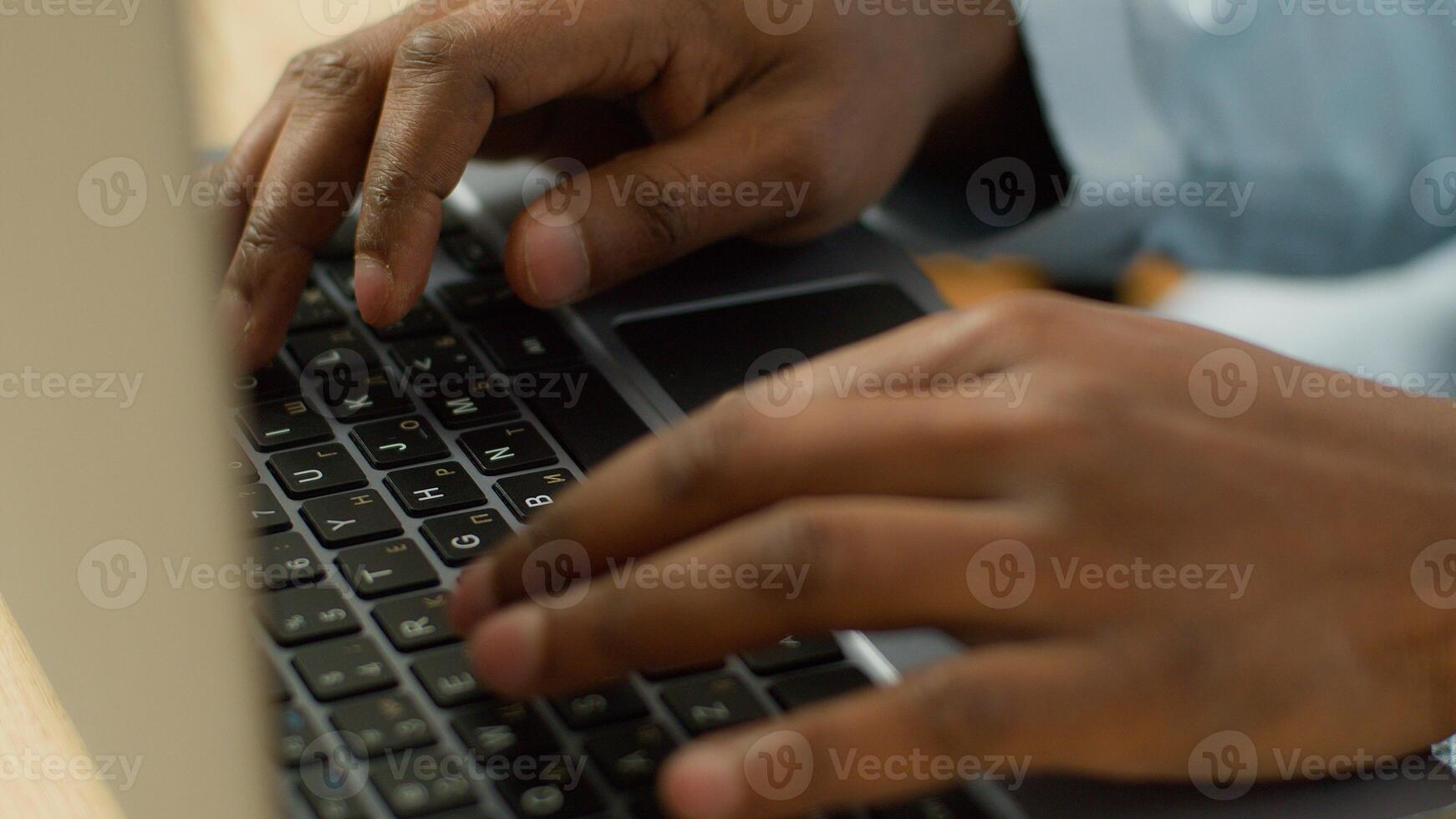 Unrecognizable biracial businessman student working studying with computer pc at table close up male African American user hands typing on laptop keyboard business worker study work online technology photo
