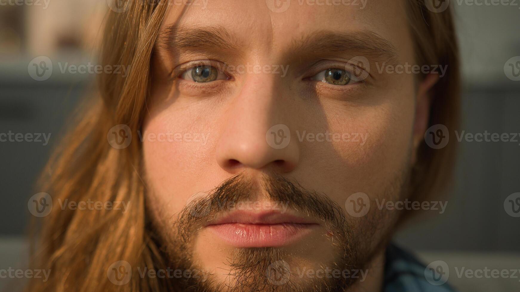 Tired sleeping man lying head leaning sofa couch wake up waking face looking at camera calm serious look portrait close up Caucasian guy male homeowner renter guy at home own apartment health napping photo