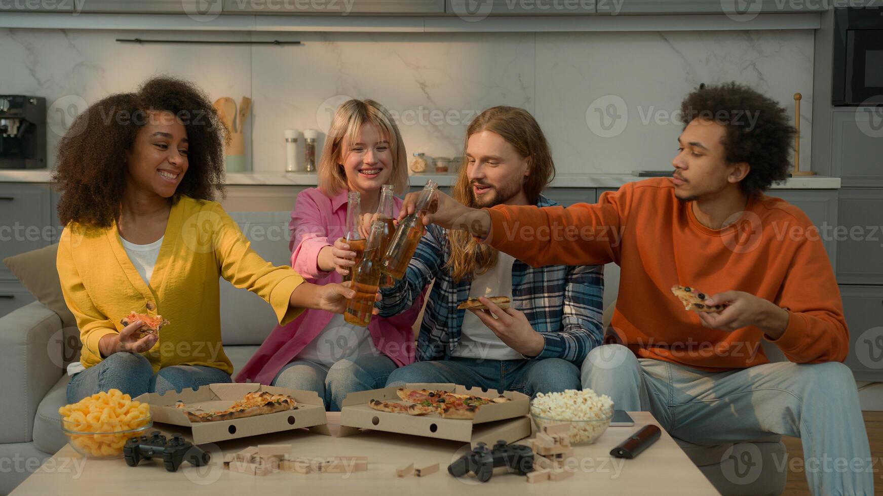 Multiracial diversity people friends together talking laugh Caucasian women men African American guys girls females males party drinking beer eating delivery pizza clink glass bottles friendship home photo