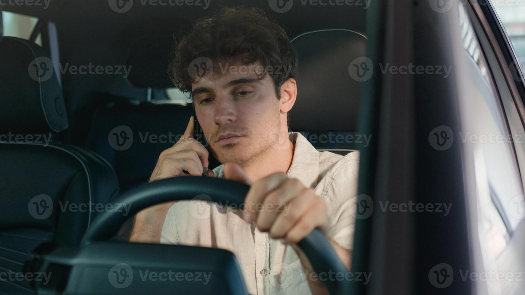Caucasian business man driver male guy driving new luxury modern electric car talking mobile phone call smiling speaking smartphone inside auto vehicle enjoy conversation cellphone in rent automobile photo