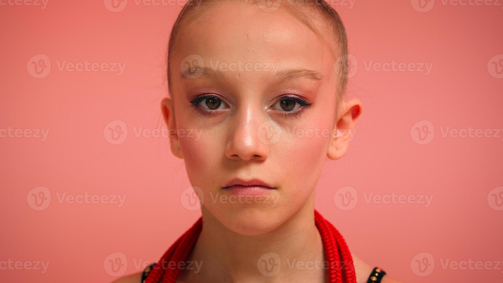 Close up portrait little girl on pink background happy Caucasian teen child kid schoolgirl daughter cute children smile female gymnast artist with makeup gymnastics sport event dancer ballerina school photo