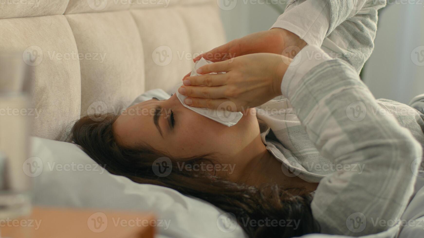 Woman on bed sneezing cough runny nose allergy bedroom home female girl unhealthy illness symptom ache discomfort disease infection pandemic sick unwell virus coronavirus flu throat respiratory suffer photo