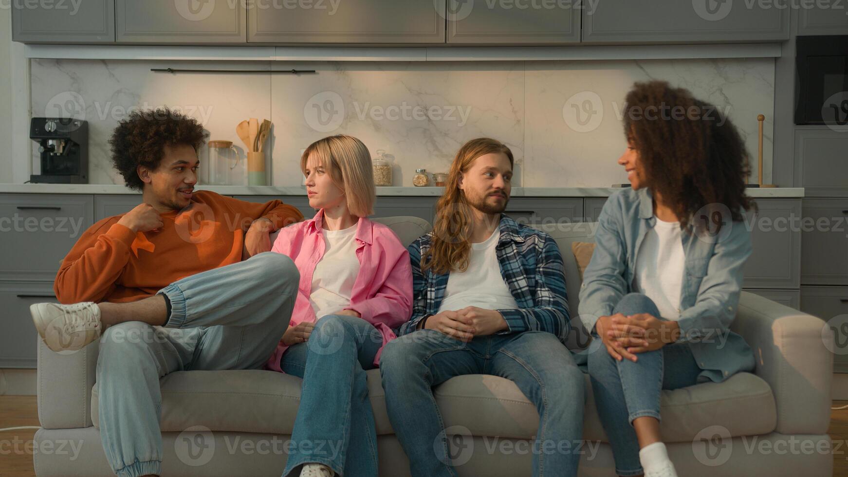 Happy smiling talking multiracial friends multiethnic people diversity men women African American guys Caucasian girls female male group talk communication together at home couch friendship weekend photo
