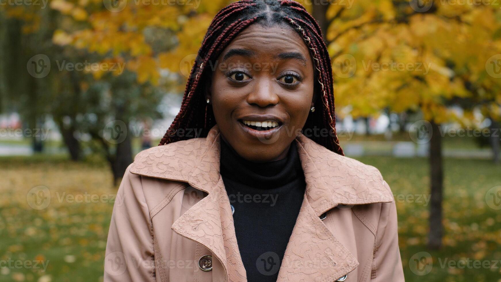 Close-up stunned african american woman standing outdoor looking at camera with eyes wide open and mouth feeling shock surprise from unexpected news amazed young female shocked expression feels wonder photo