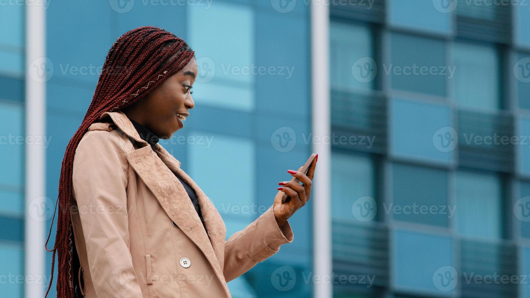 Close-up young happy woman standing in autumn park communicates chat on smartphone friendly online conversation joyful smiling girl talking with friend on webcam on phone answering call photo