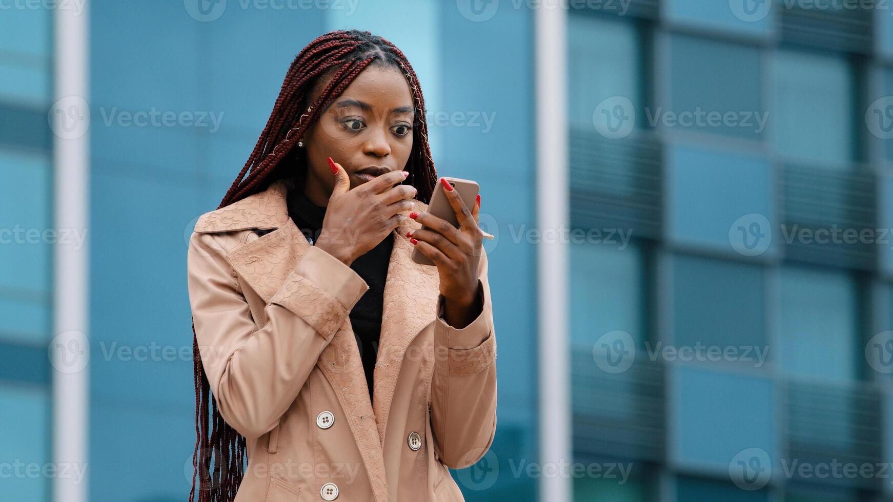 Upset shocked young woman standing outdoors receiving email on cellphone reading bad news sad distressed girl feels frustration after reads sms suffering from desperation hopelessness failure concept photo