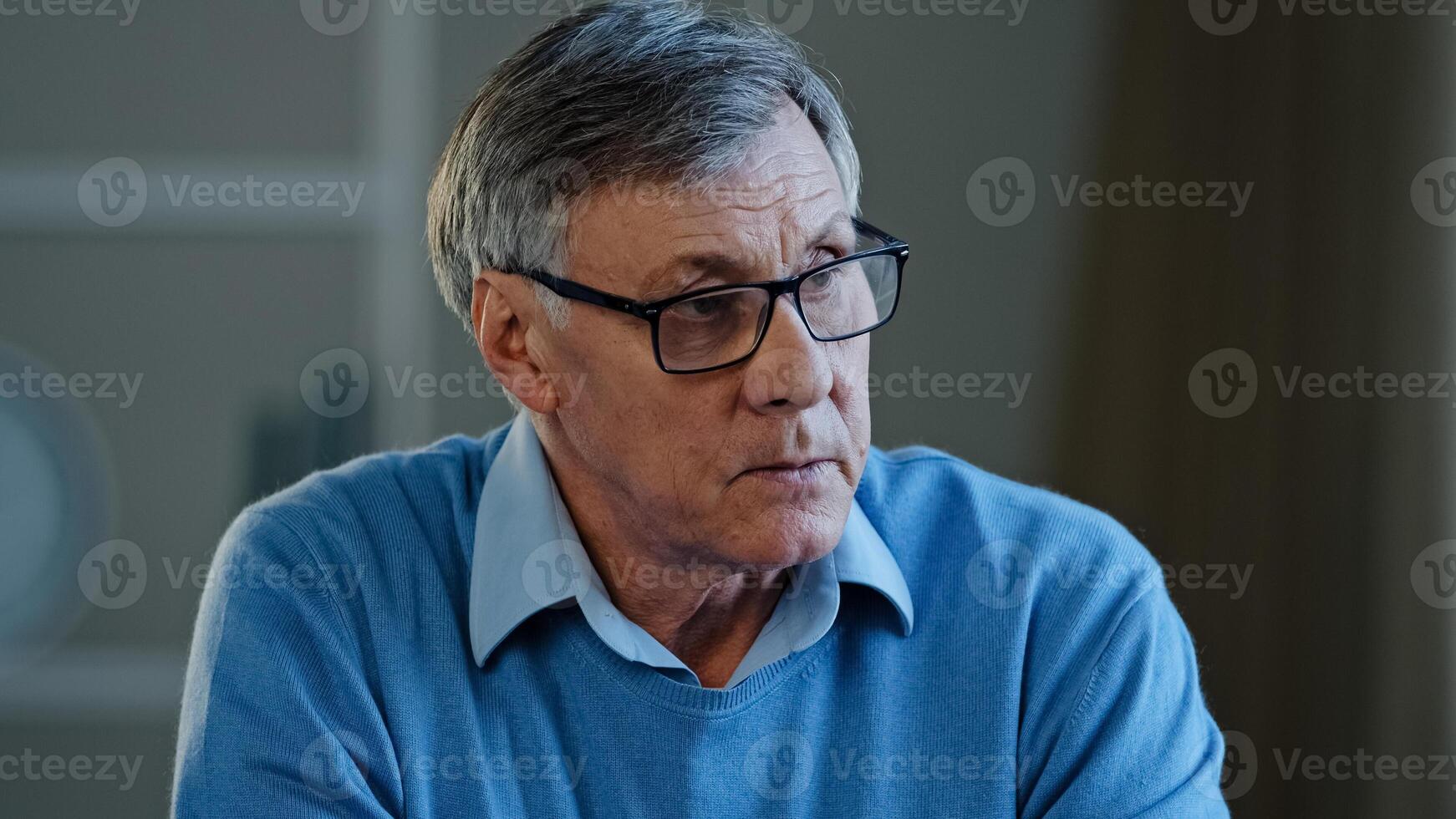 Close up old thoughtful pensive confused senior man feel worried think memory problem forgotten information, elderly old teacher look away anxious about trouble in office at home thinking pondering photo