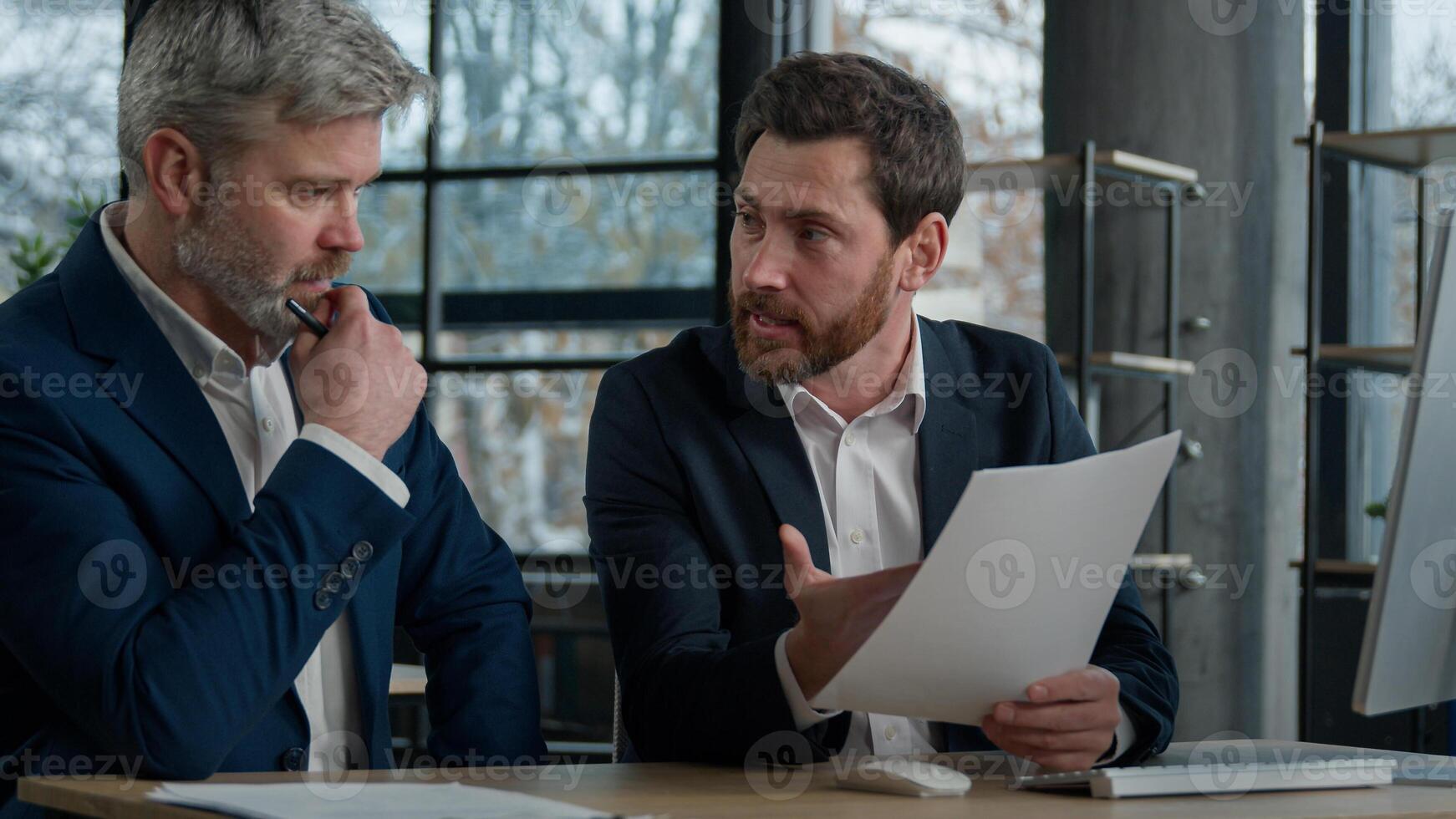 Two disgruntled furious Caucasian businessmen arguing about bad contract in office men colleagues partners dispute incorrect document failed transaction deal conflict problem shouting break agreement photo